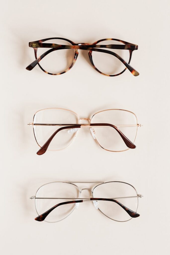 Stylish diverse glasses arranged in row lying down glasses on beige table
