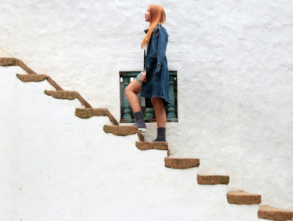 woman climbing on brown concrete stairs