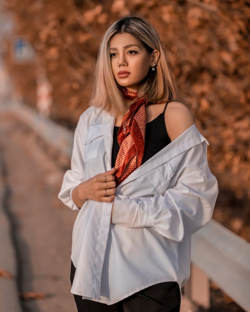 a woman wearing a white shirt and a red neck tie