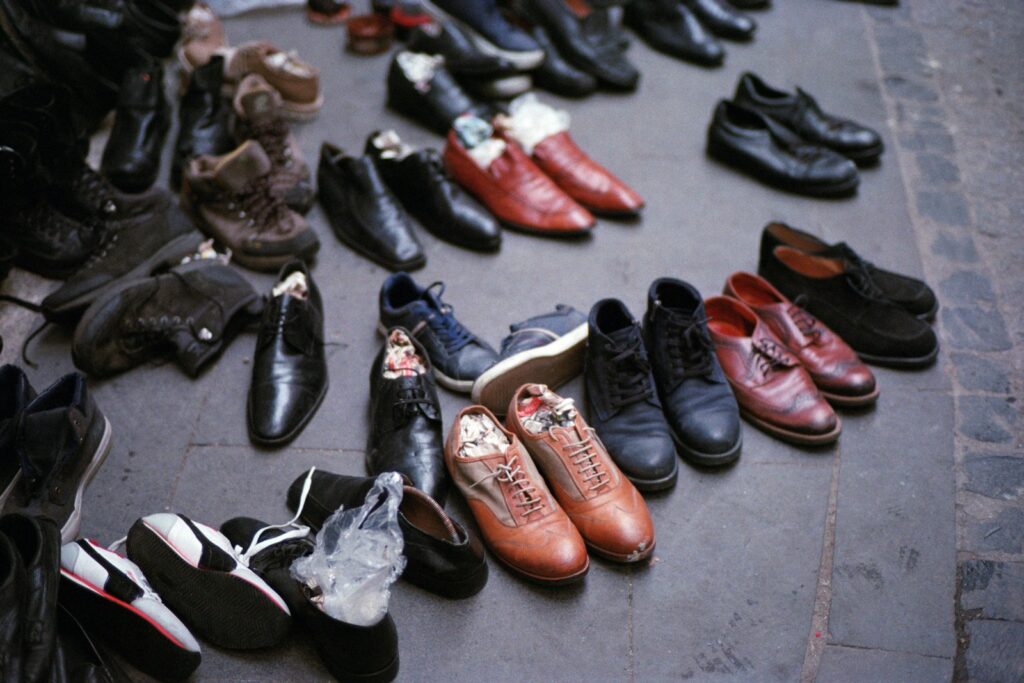 a bunch of shoes that are laying on the ground