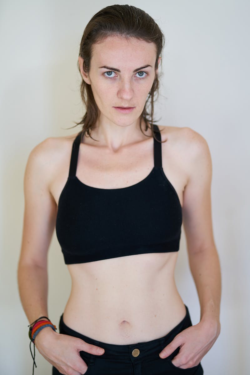 Portrait of a young woman in a sports bra exuding confidence and focus.
