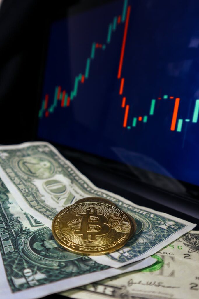 Close-up of Bitcoin on dollar bills with trading chart background, symbolizing cryptocurrency and finance.