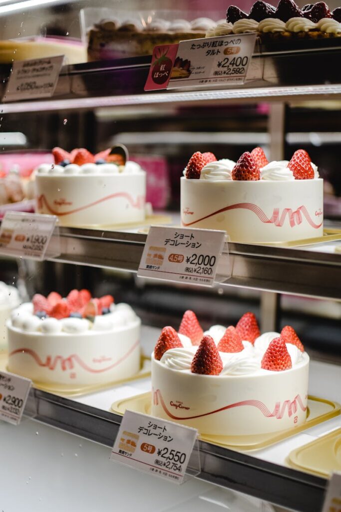 Mouthwatering strawberry shortcakes displayed in a bakery showcase.