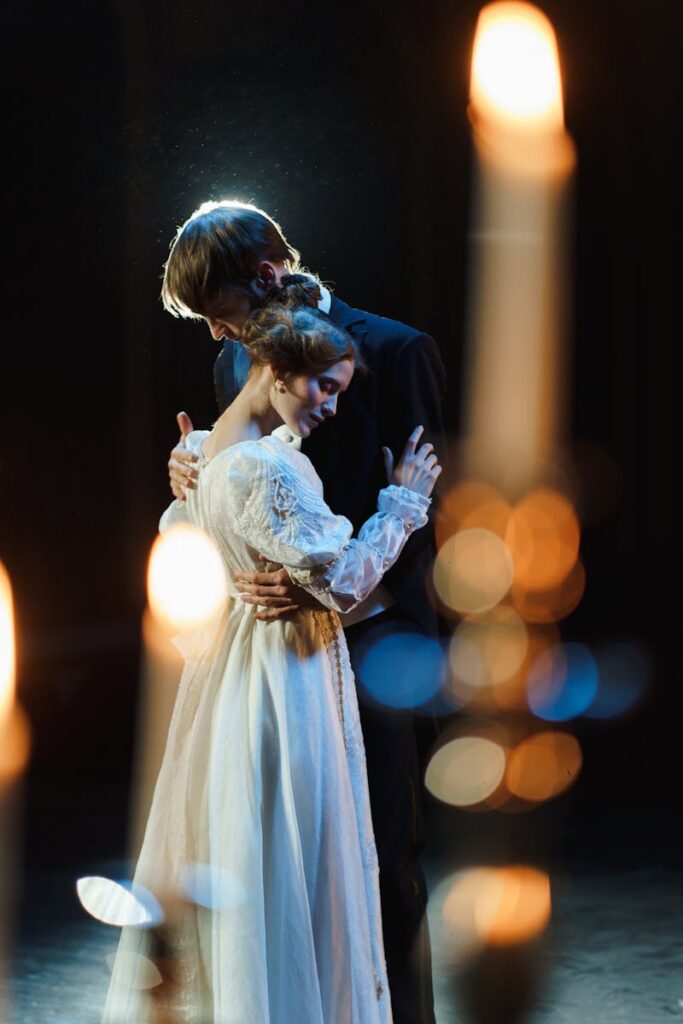 A romantic scene featuring a couple embracing on stage in a theatrical setting, exuding elegance and emotion.