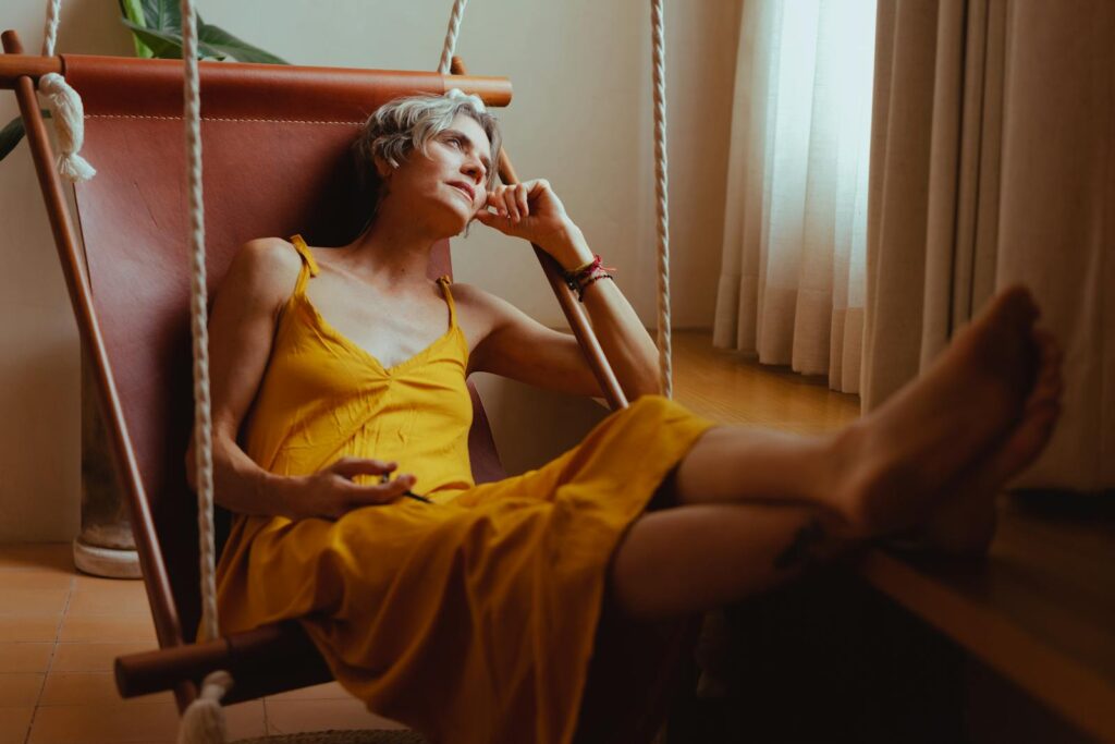 Senior woman relaxing in a hammock indoors, embracing positive aging and tranquility.