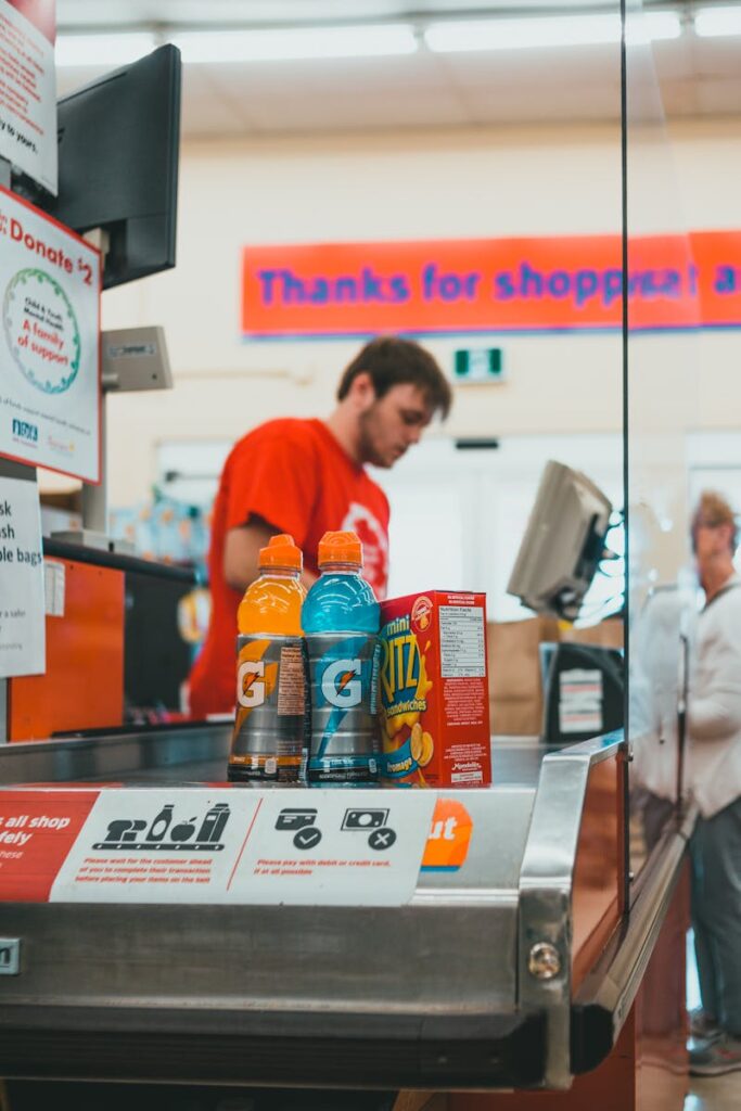 Close-up of a checkout counter with energy drinks and snacks in a grocery store.