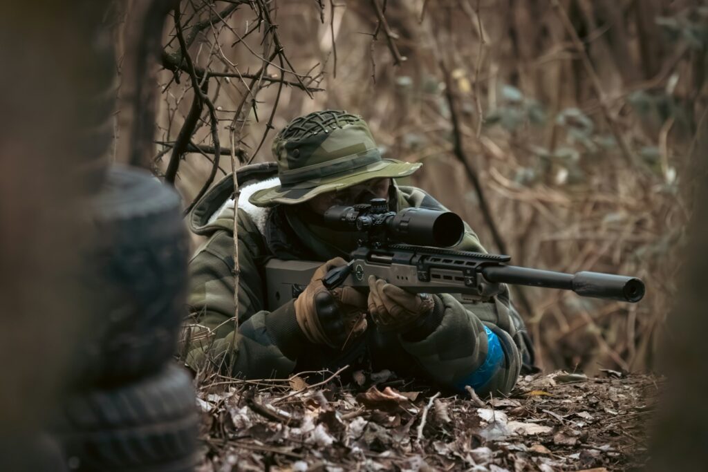 A man with a gun in the woods