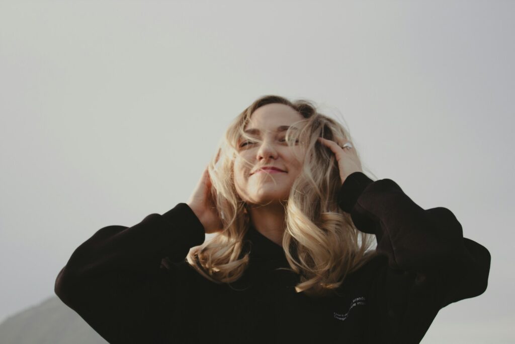 a woman with blonde hair wearing a black shirt