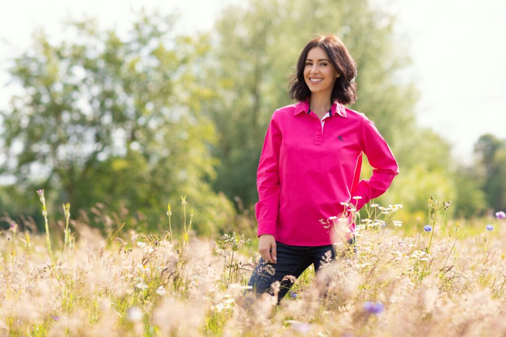 A woman standing in a field of tall grass