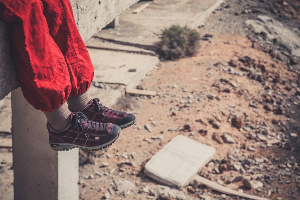person in red pants and black and white sneakers