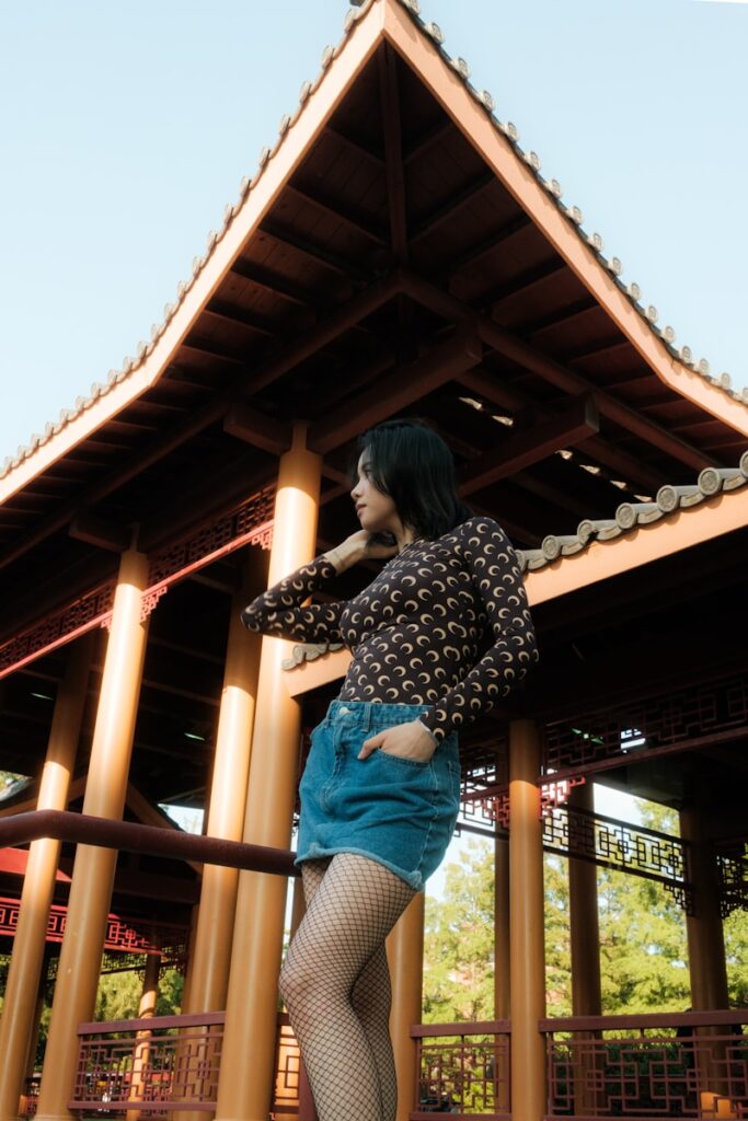 A woman standing on a skateboard in front of a building