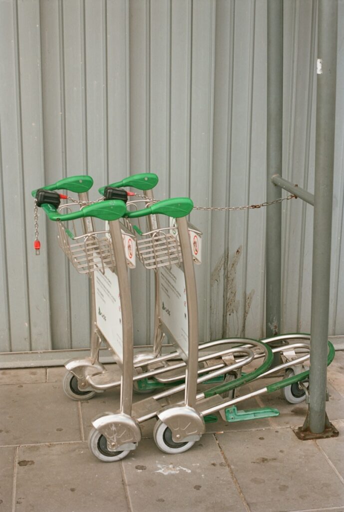 A group of green chairs sitting on top of a metal cart