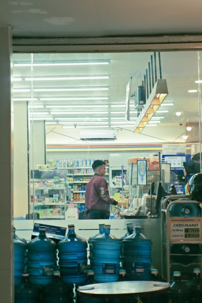 a man standing in front of a store filled with water