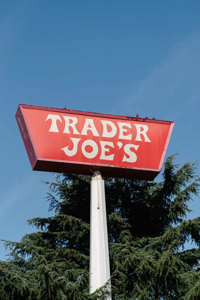 A red trader joe's sign on top of a pole