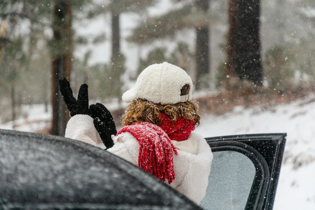 a person in a car waving out the window
