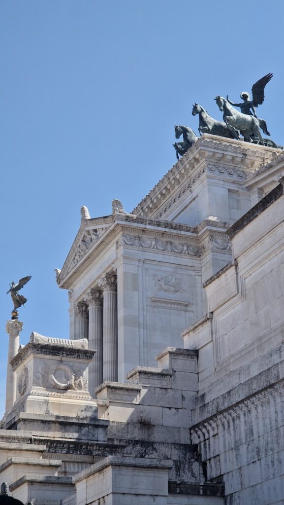 A tall building with statues on top of it