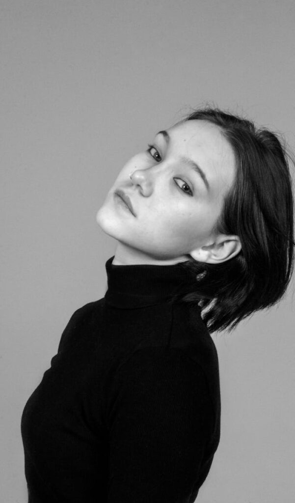 Monochrome portrait of a woman in a turtleneck, exuding elegance and simplicity.