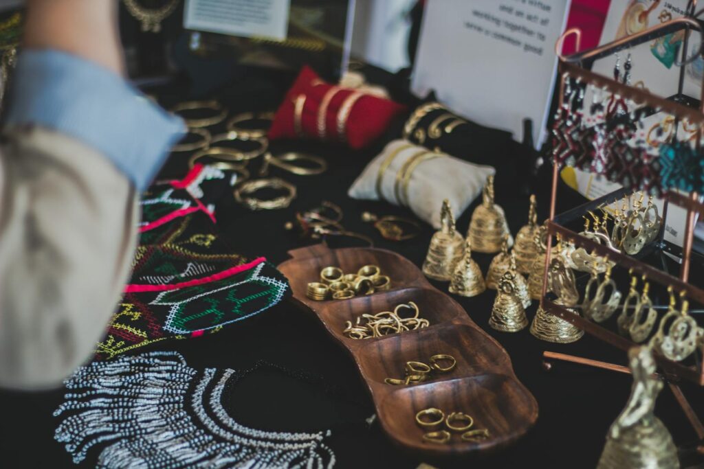 Close-up of a variety of elegant jewelry, including rings, earrings, and necklaces on display indoors.