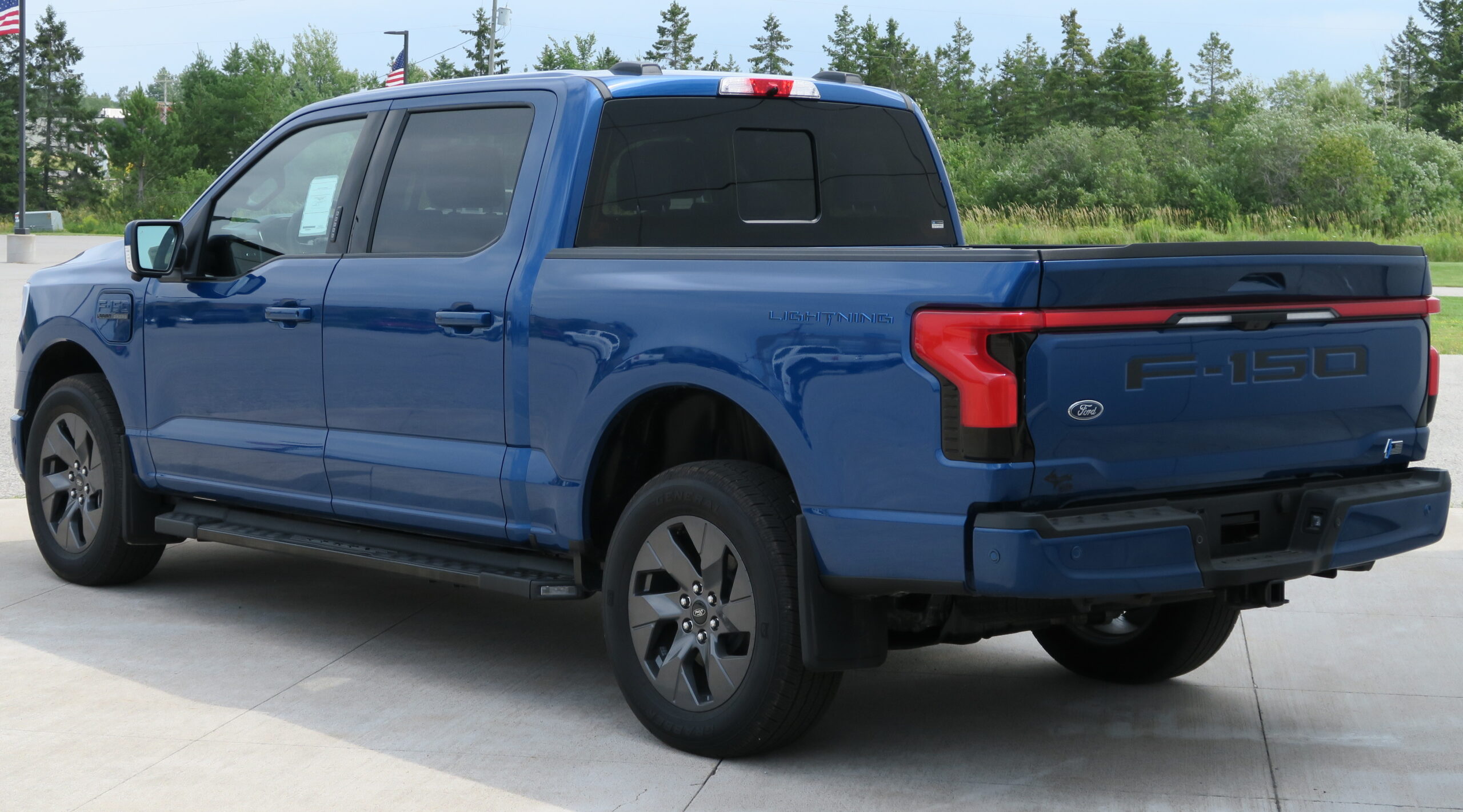 2022 Ford F-150 Lightning Lariat in Atlas Blue Metallic, Rear Left, 08-06-2022