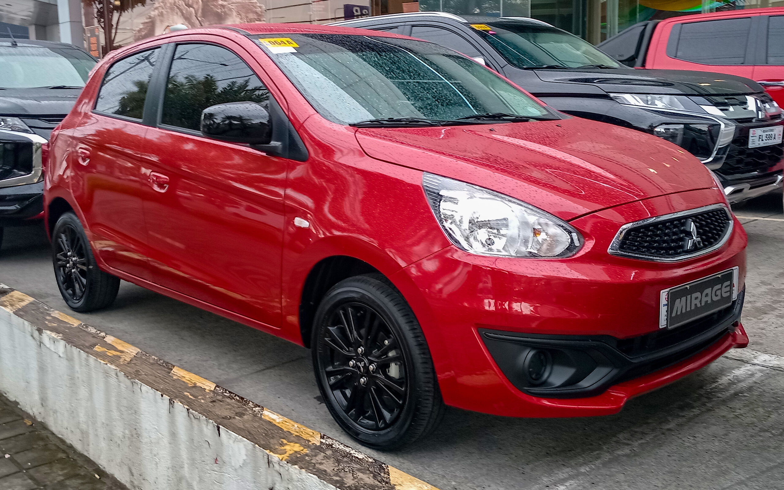 2024 Mitsubishi Mirage 1.2 GLX in Red Metallic, front right, 07-04-2024