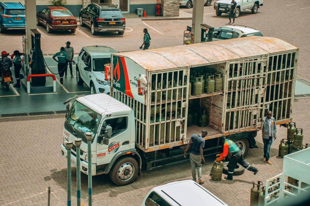 An LPG gas truck making a delivery at a busy urban station.