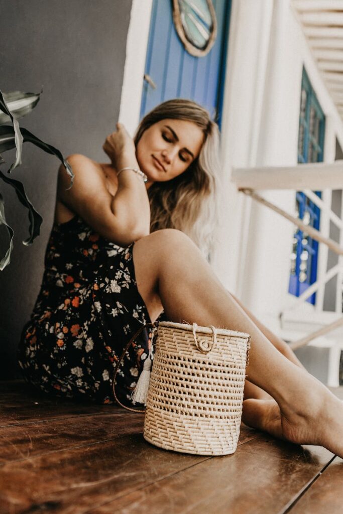 A young woman sitting peacefully with eyes closed, basking in the summer ambiance.