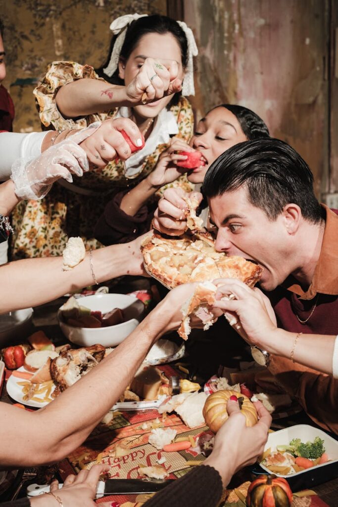 Energetic group enjoying Thanksgiving dinner with a festive, playful atmosphere.