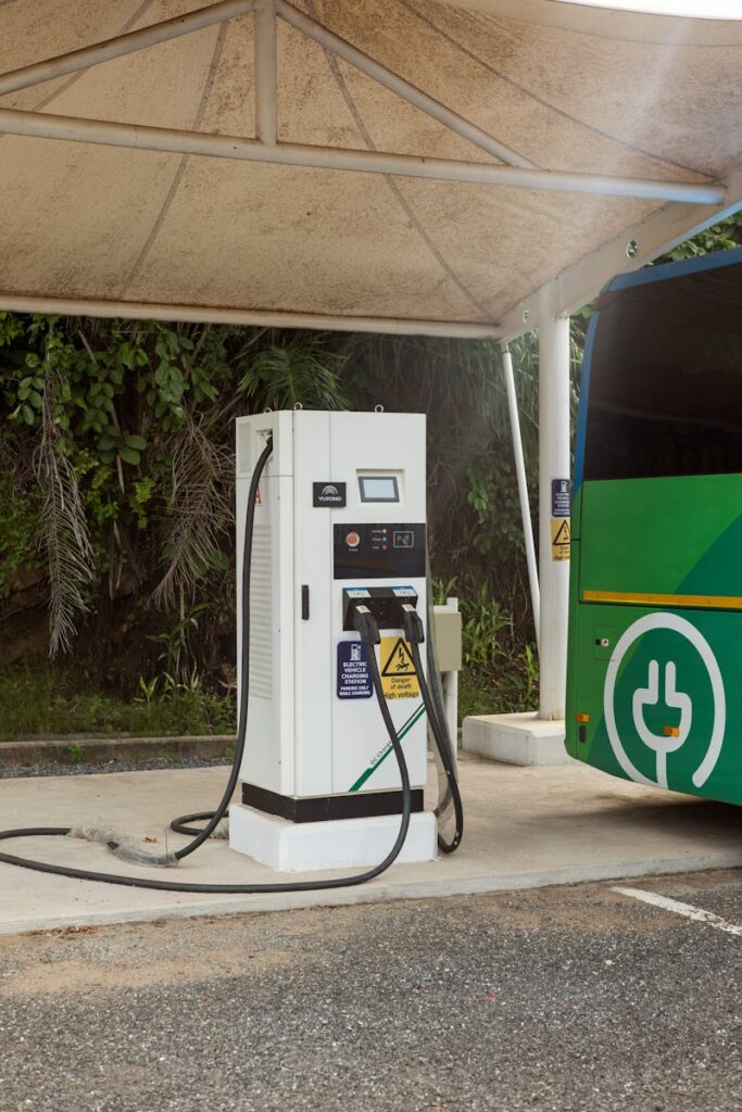 A public electric bus charging station under a canopy, ready for eco-friendly travel.
