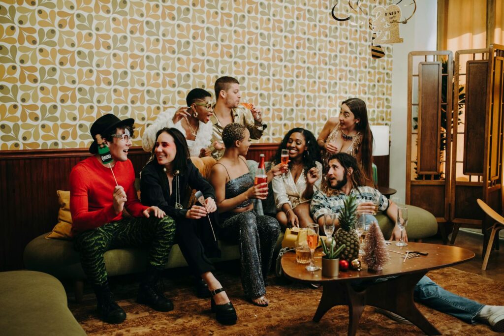A lively celebration with friends enjoying drinks and festive decor indoors.