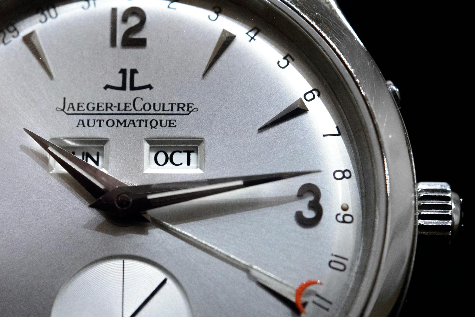 Detailed close-up of a Jaeger-LeCoultre wristwatch, showcasing its elegant dial and features.