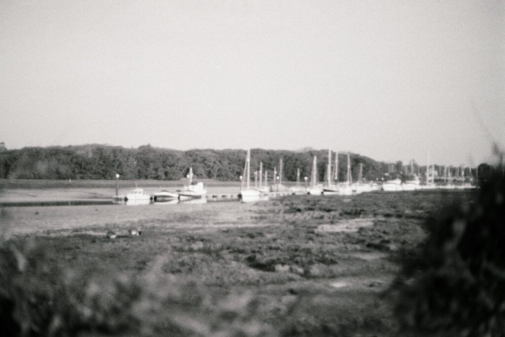 a black and white photo of boats in a harbor