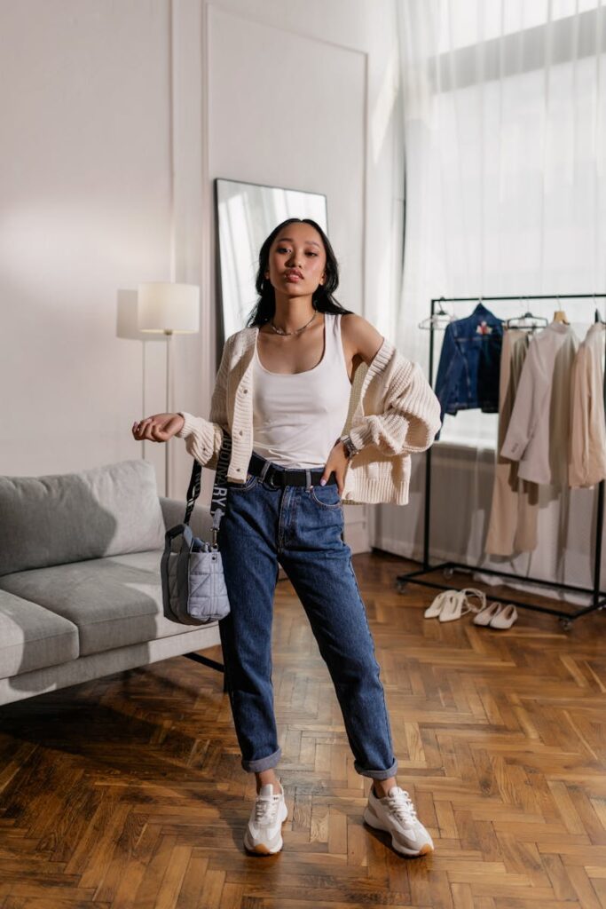 Stylish Asian woman in casual wear posing confidently indoors.