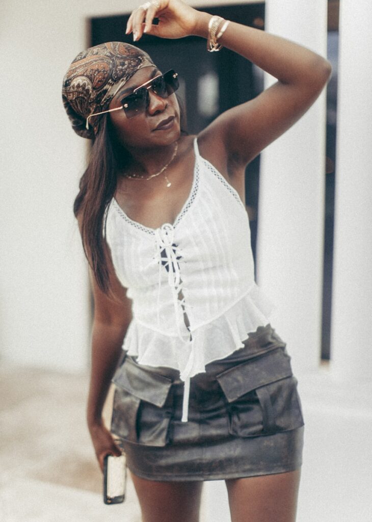 A woman poses in stylish attire.