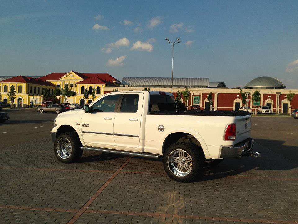 A Black Aluminum Heavy Duty Truck Cover On A White Dodge Ram