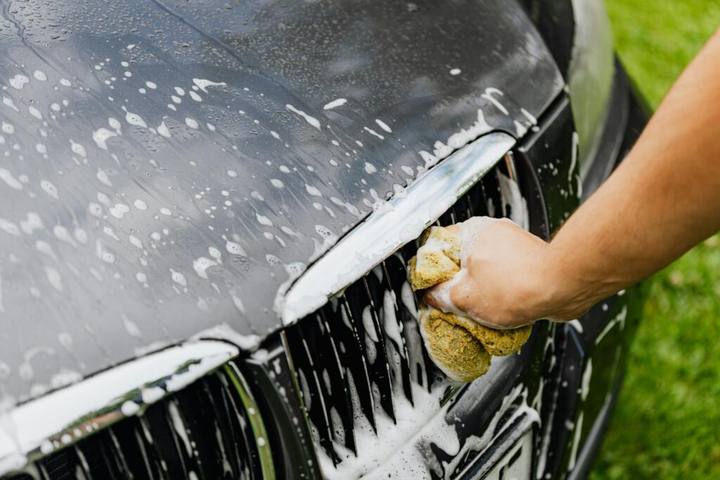 A Person Washing a Car Grill