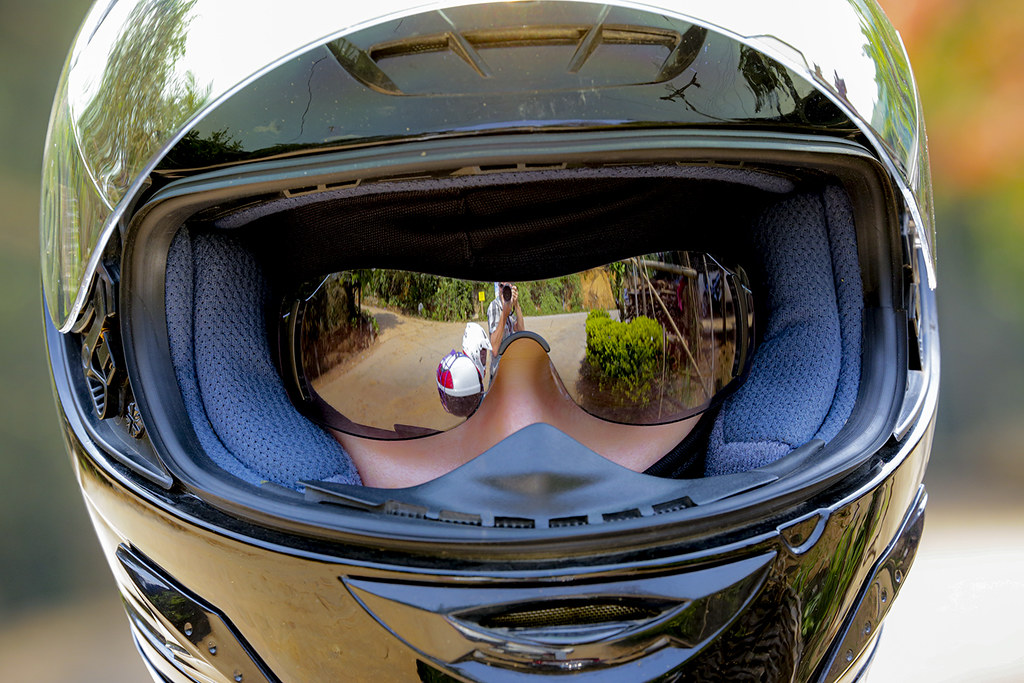 A girl in a motorcycle helmet and mirrored glasses, which reflects the photographer AD4A3237bs