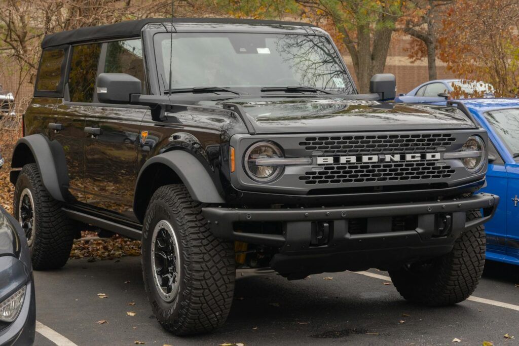 A modern black Ford Bronco SUV parked outdoors in a fall setting.