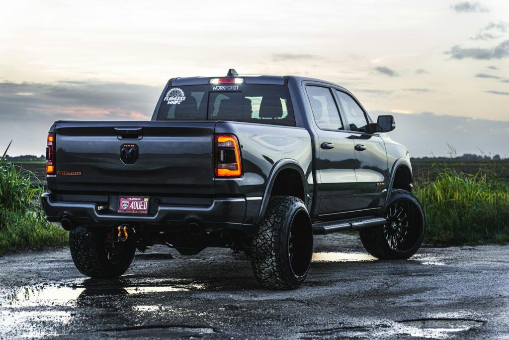 A powerful pickup truck parked on a gravel road at dusk. Perfect for automotive enthusiasts.