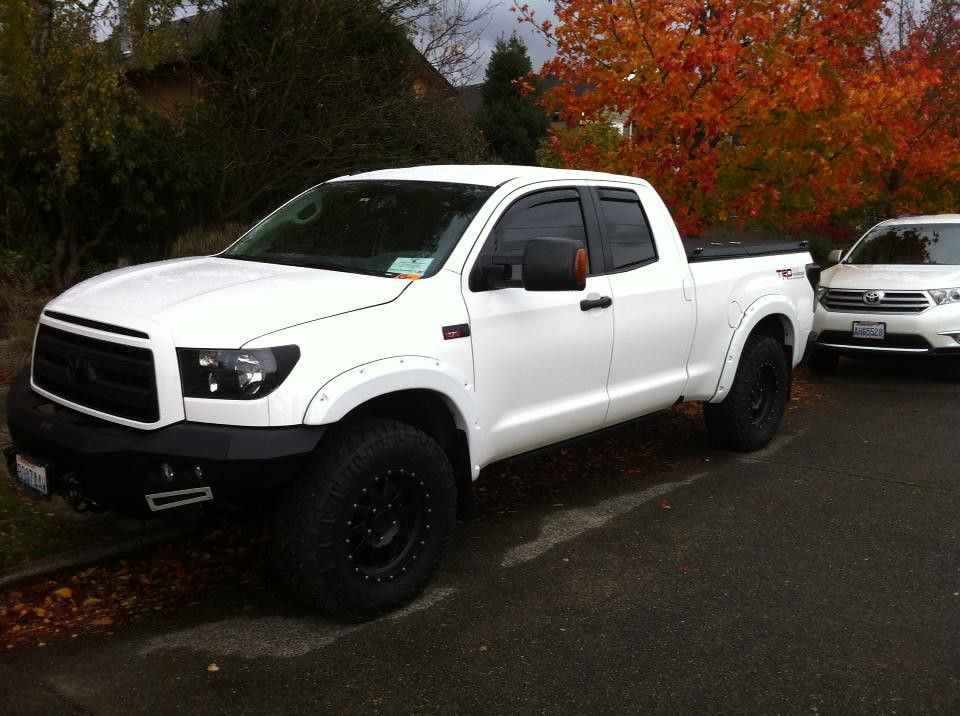 Black Folding Truck Bed Cover on White Toyota Tundra