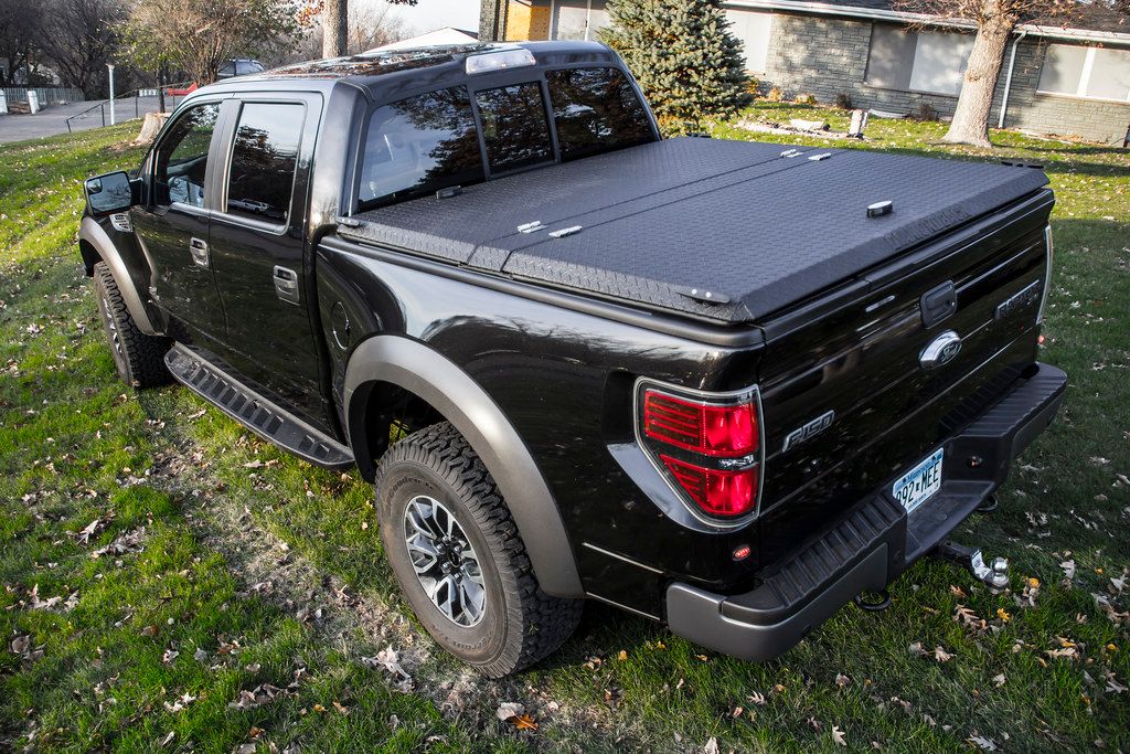 Black Ford F-150 Raptor with Black Folding Truck Bed Cover
