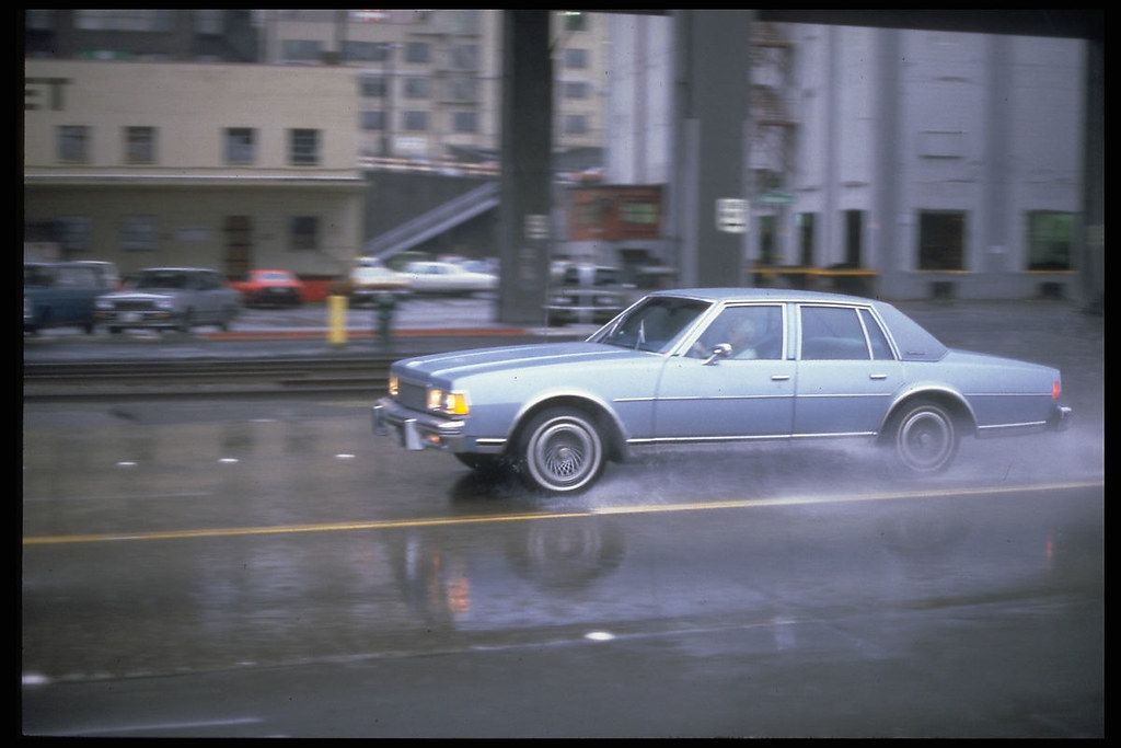 Car in rain, 1980s