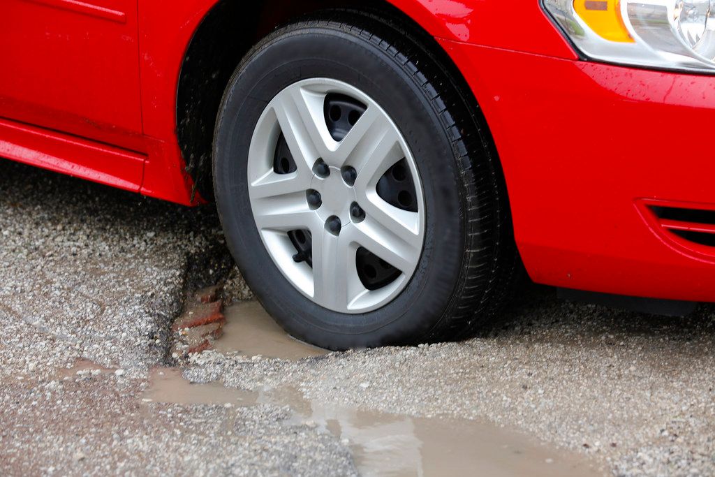 Car tire hitting pothole