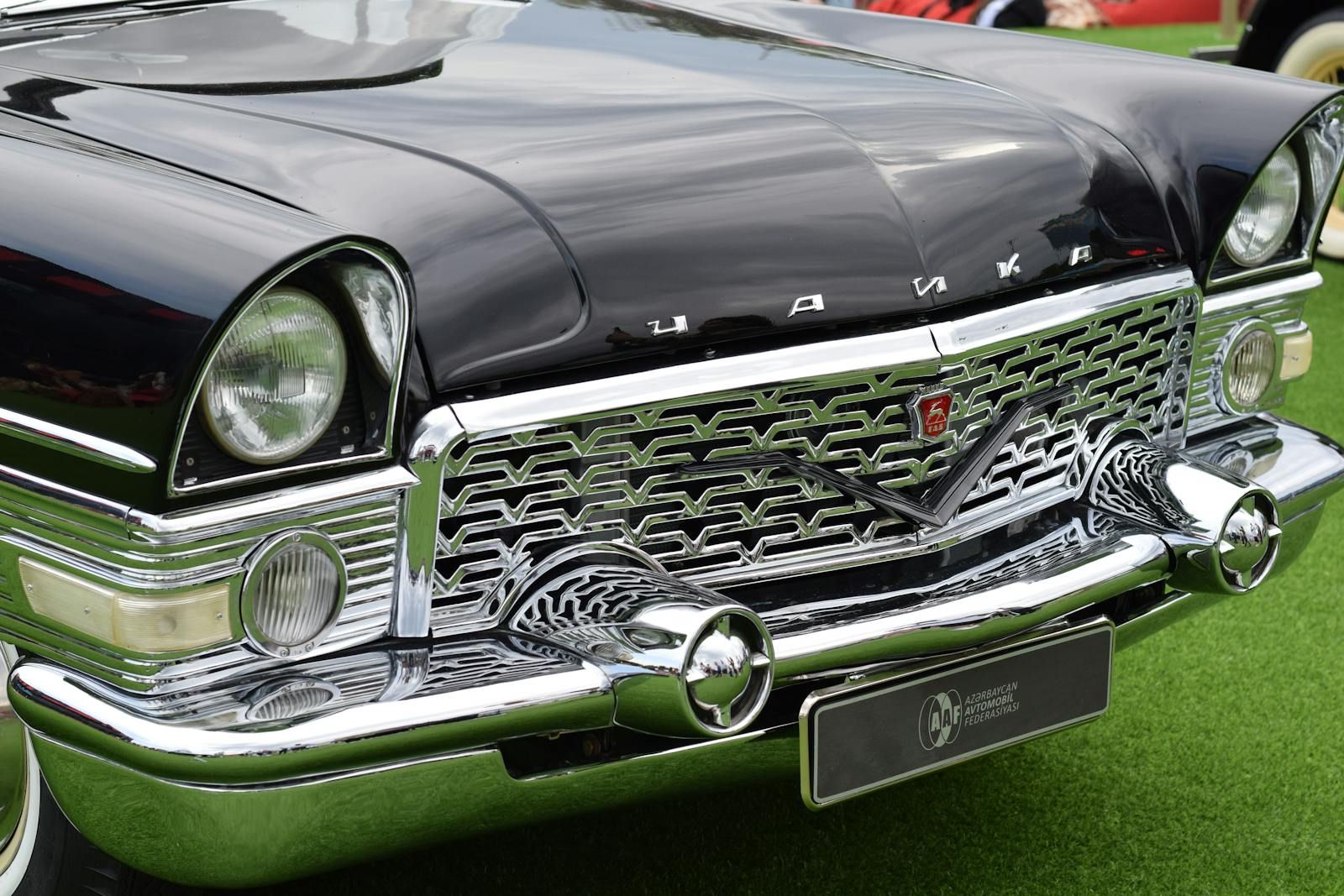 Close-up of a classic Soviet luxury sedan showcasing a chrome front grille.
