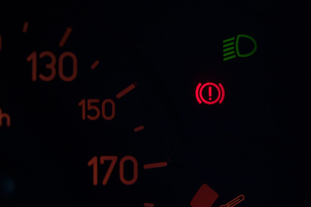 Close-up of parking brake warning light on car dashboard