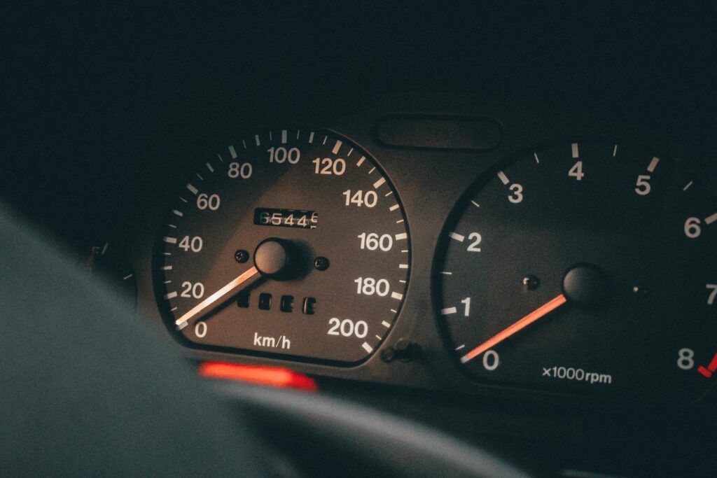 Detailed view of a car's speedometer and tachometer displaying speed and RPM.