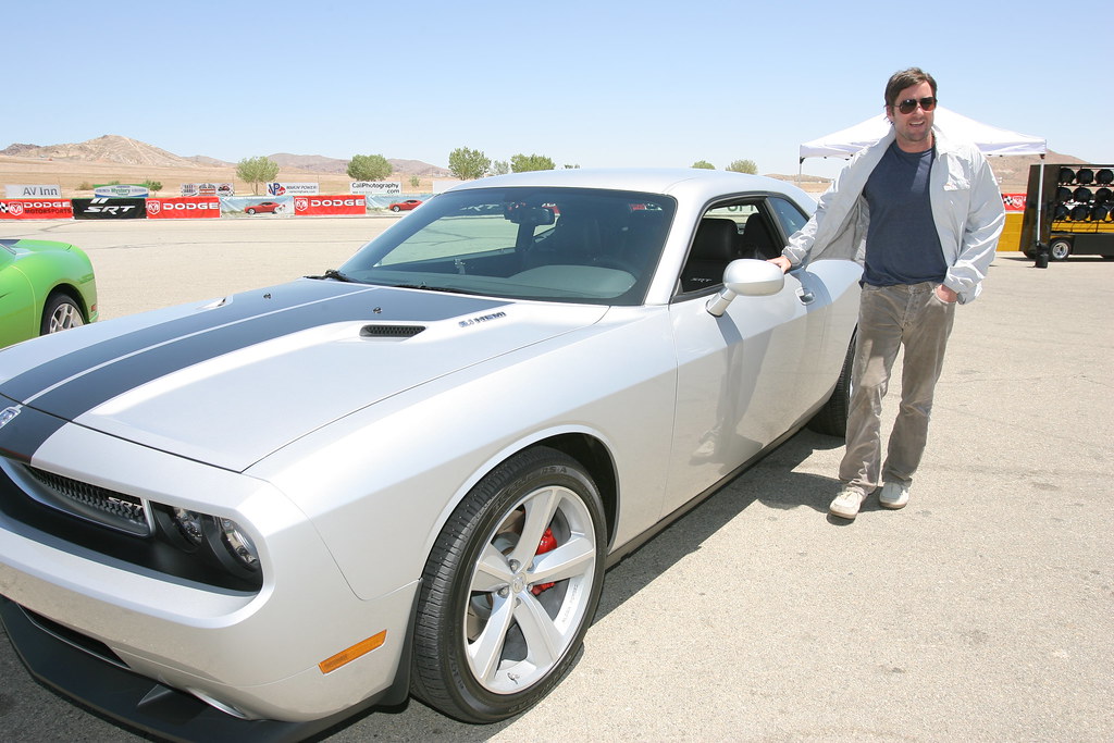 Luke Wilson posing with the All-New Dodge Challenger