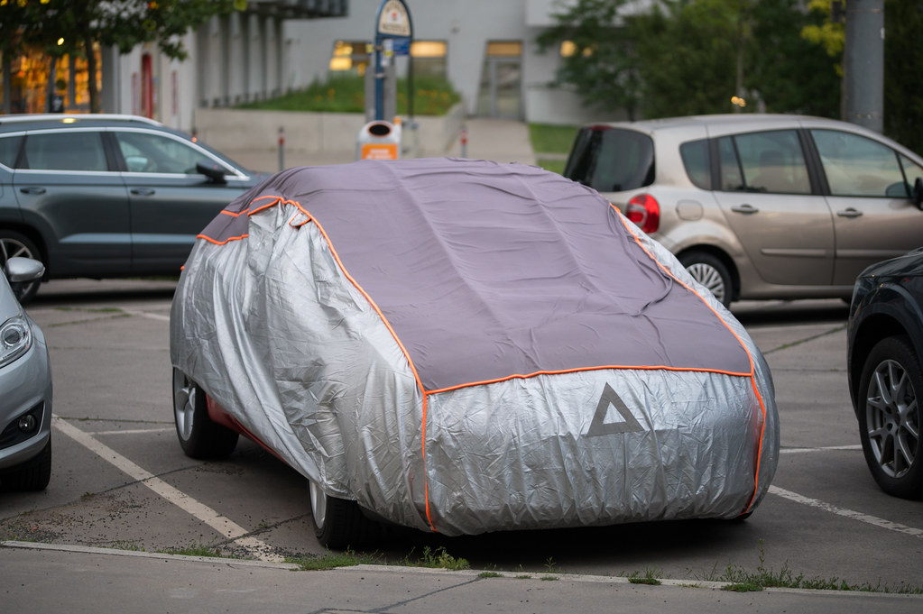 Outdoor car cover on a parked automobile