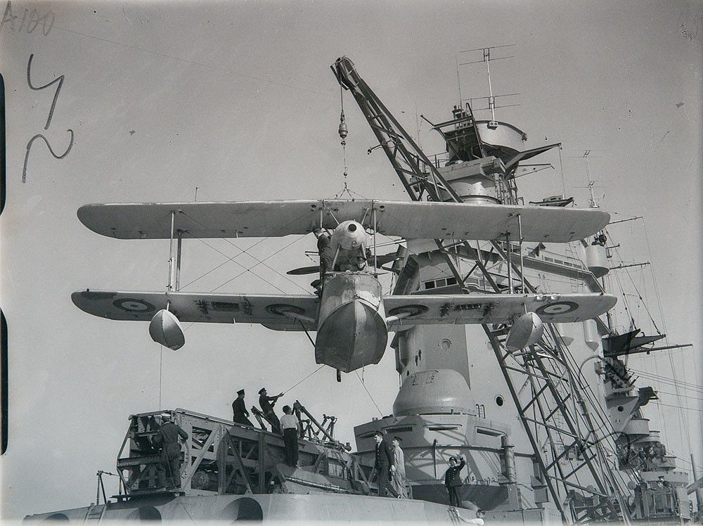 Supermarine Walrus being hoisted onto HMS RODNEY