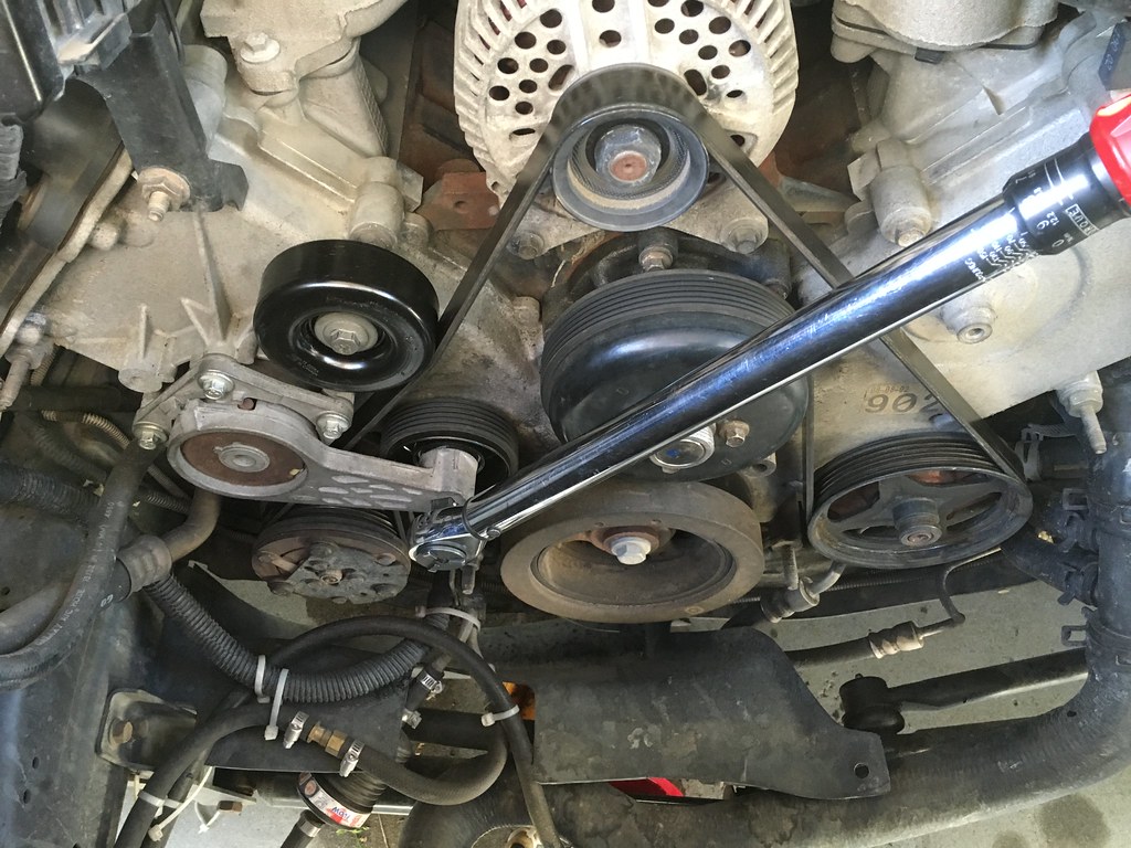 Unloading the spring-loaded, adjustable idler, needed to allow installing of the serpentine belt.
