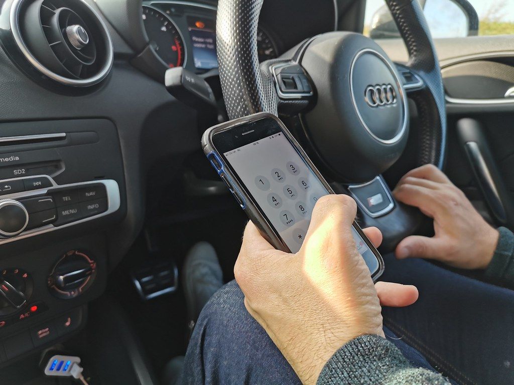 Using a mobile phone while driving stock photo